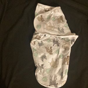 White baby swaddle her with animals on it